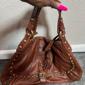 Brown leather hobo with gold grommets